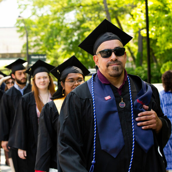 BardBac graduate leads procession during commencement.