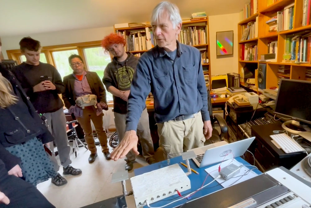 Professor demonstrating a musical instrument.