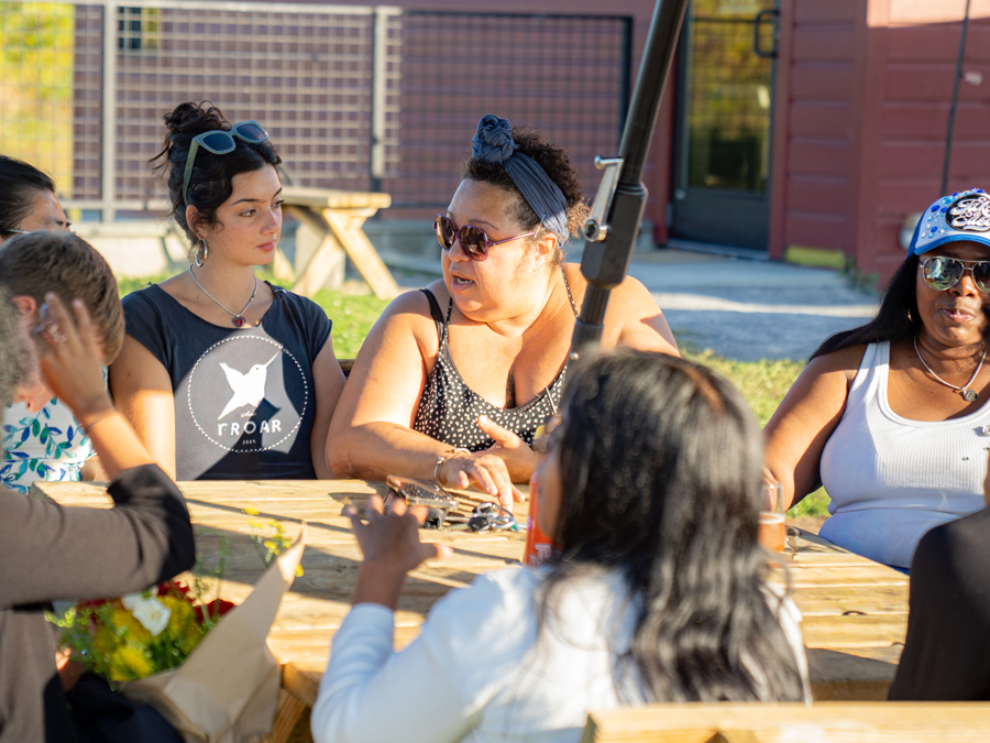 Group of students sitting outside around a table.